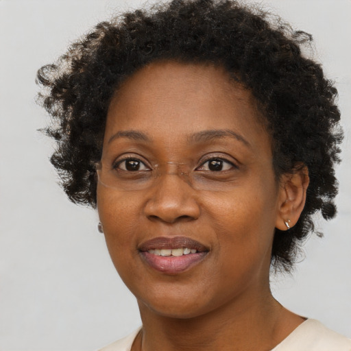 Joyful black adult female with short  brown hair and brown eyes