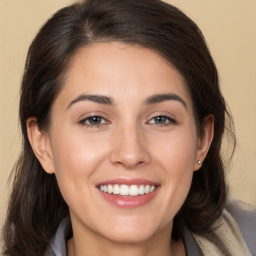 Joyful white young-adult female with medium  brown hair and brown eyes