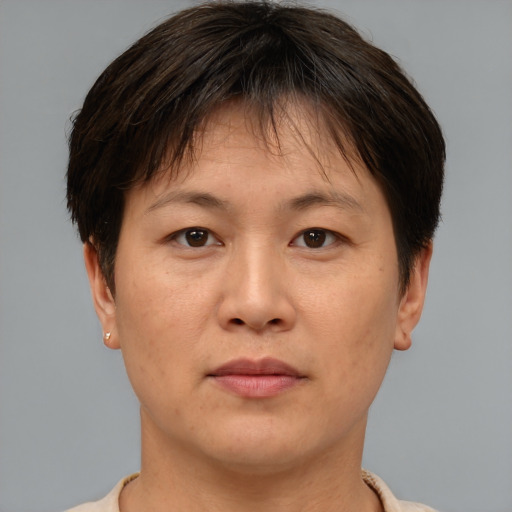 Joyful asian adult female with short  brown hair and brown eyes