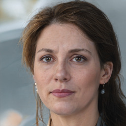 Joyful white adult female with medium  brown hair and brown eyes