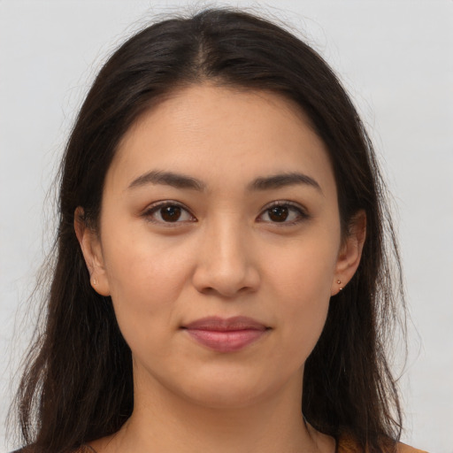 Joyful latino young-adult female with long  brown hair and brown eyes