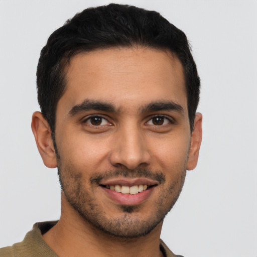 Joyful latino young-adult male with short  brown hair and brown eyes