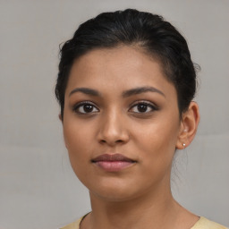Joyful latino young-adult female with short  brown hair and brown eyes