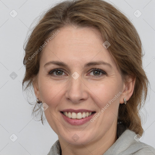 Joyful white adult female with medium  brown hair and grey eyes