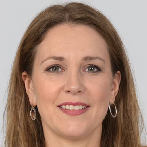 Joyful white adult female with long  brown hair and grey eyes