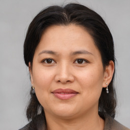 Joyful asian adult female with medium  brown hair and brown eyes