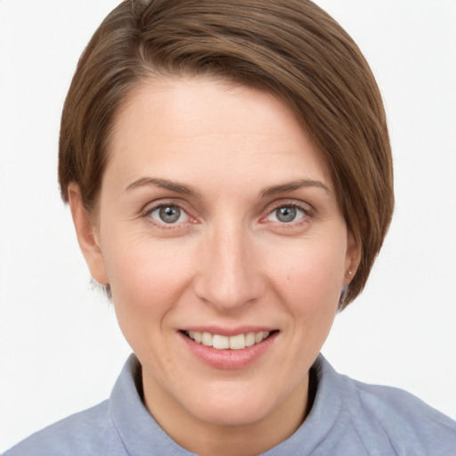 Joyful white young-adult female with short  brown hair and grey eyes