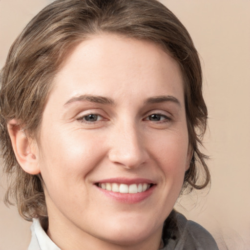 Joyful white young-adult female with medium  brown hair and grey eyes