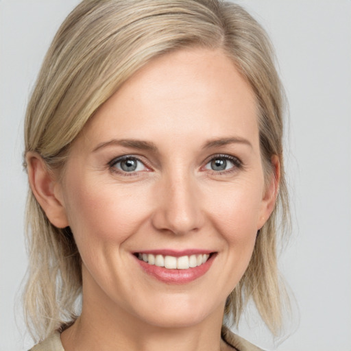 Joyful white young-adult female with medium  blond hair and blue eyes