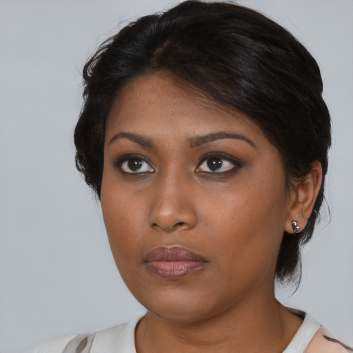Neutral black young-adult female with medium  brown hair and brown eyes