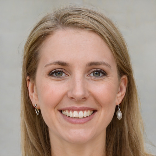 Joyful white young-adult female with long  brown hair and blue eyes