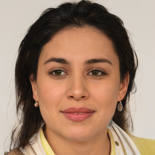 Joyful latino young-adult female with medium  brown hair and brown eyes