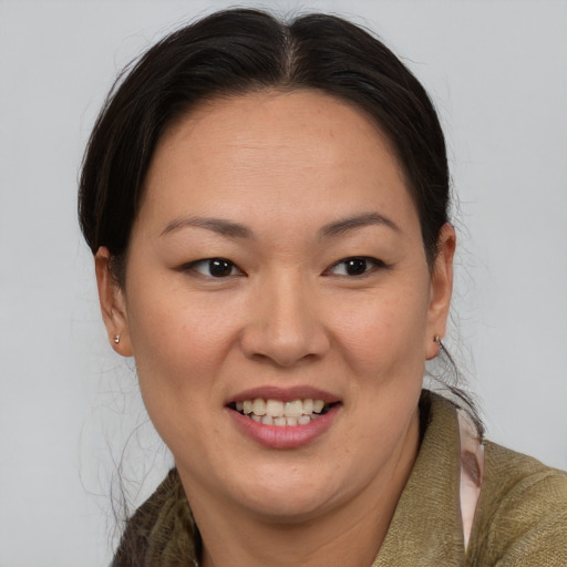 Joyful latino adult female with short  brown hair and brown eyes