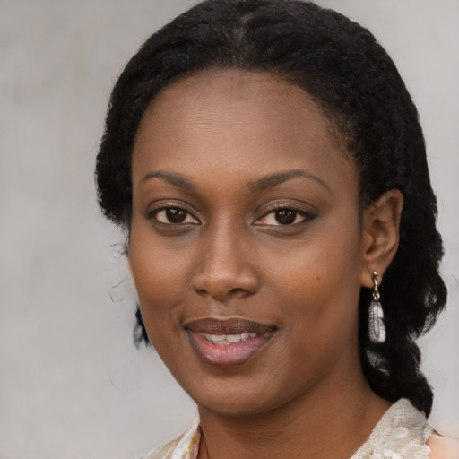 Joyful black young-adult female with medium  black hair and brown eyes