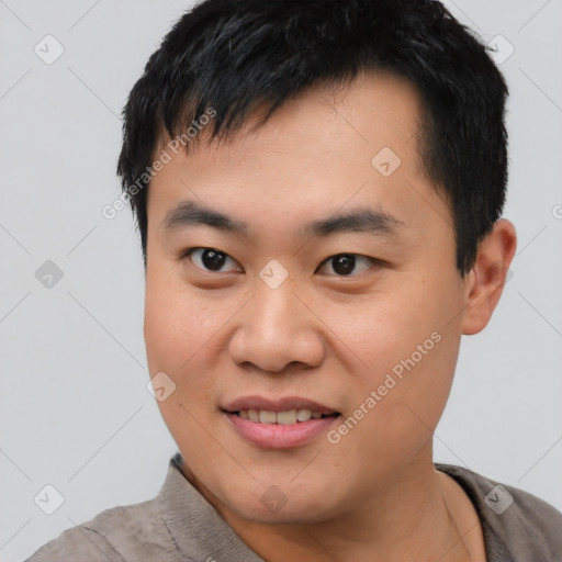 Joyful asian young-adult male with short  black hair and brown eyes