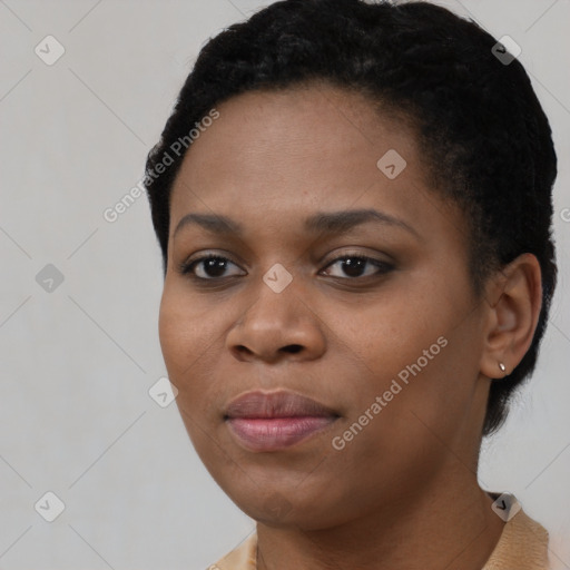 Joyful black young-adult female with short  black hair and brown eyes