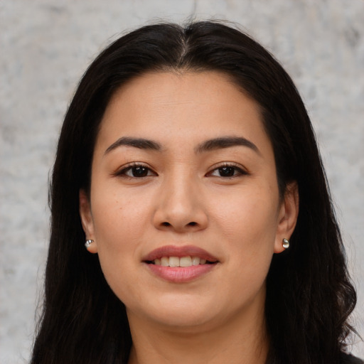 Joyful asian young-adult female with long  brown hair and brown eyes