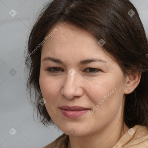 Joyful white adult female with long  brown hair and brown eyes