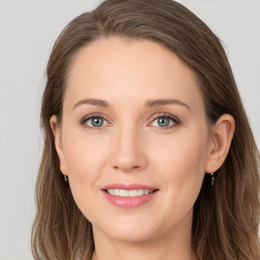 Joyful white young-adult female with long  brown hair and grey eyes