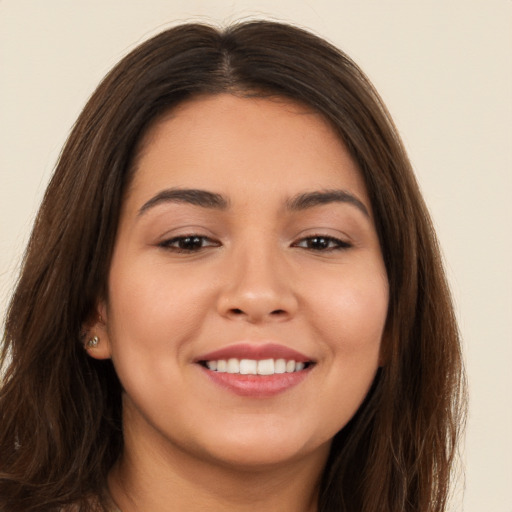 Joyful white young-adult female with long  brown hair and brown eyes