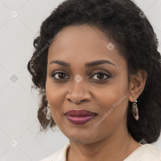 Joyful black young-adult female with long  brown hair and brown eyes