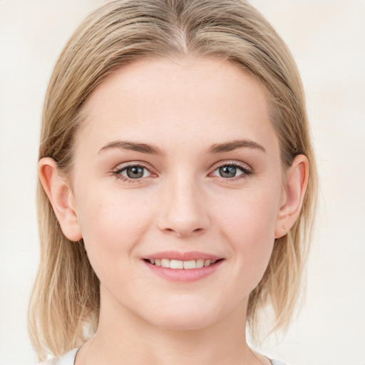 Joyful white young-adult female with medium  brown hair and blue eyes