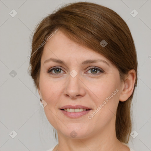 Joyful white young-adult female with medium  brown hair and grey eyes