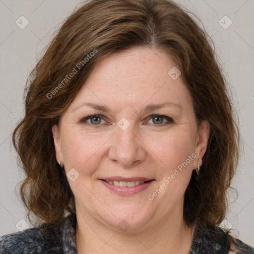 Joyful white adult female with medium  brown hair and grey eyes