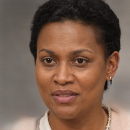 Joyful black adult female with short  brown hair and brown eyes