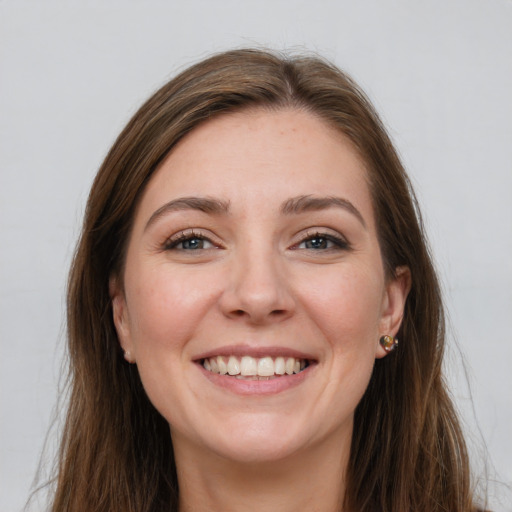 Joyful white young-adult female with long  brown hair and grey eyes