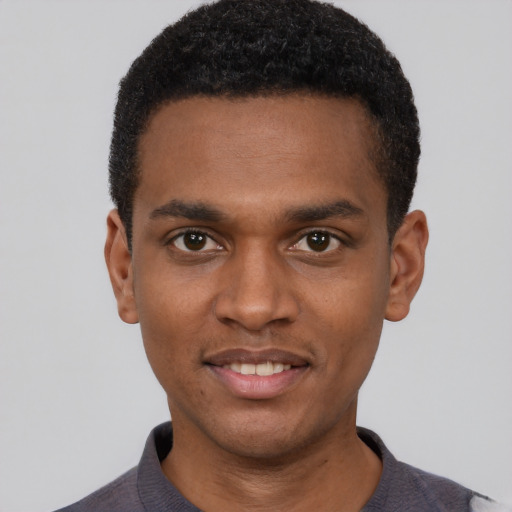 Joyful black young-adult male with short  black hair and brown eyes