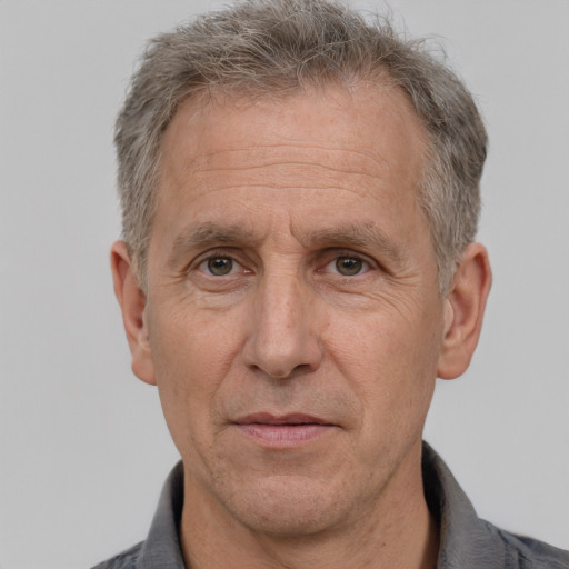 Neutral white middle-aged male with short  gray hair and brown eyes