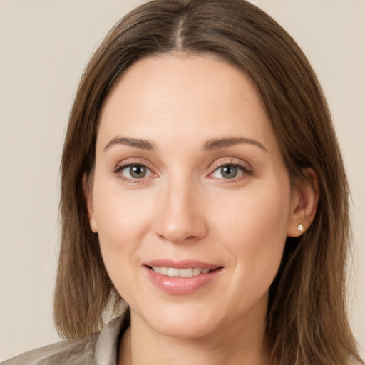 Joyful white young-adult female with long  brown hair and green eyes