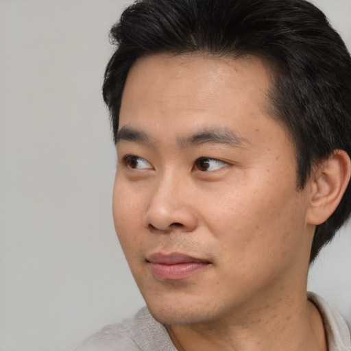 Neutral asian young-adult male with short  black hair and brown eyes