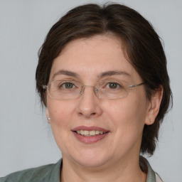 Joyful white adult female with medium  brown hair and brown eyes