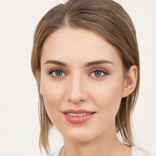 Joyful white young-adult female with medium  brown hair and grey eyes