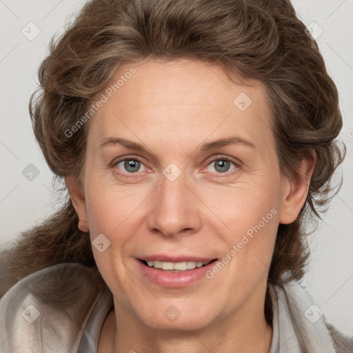 Joyful white adult female with medium  brown hair and blue eyes