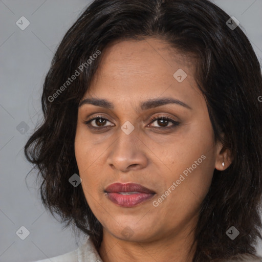 Joyful white adult female with medium  brown hair and brown eyes