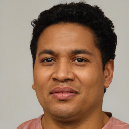 Joyful latino young-adult male with short  brown hair and brown eyes