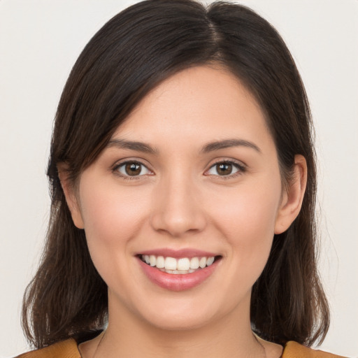 Joyful white young-adult female with long  brown hair and brown eyes