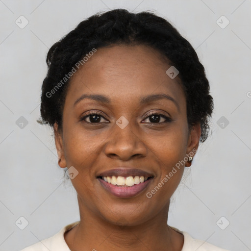 Joyful black young-adult female with short  black hair and brown eyes