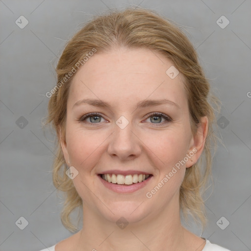 Joyful white young-adult female with medium  brown hair and blue eyes