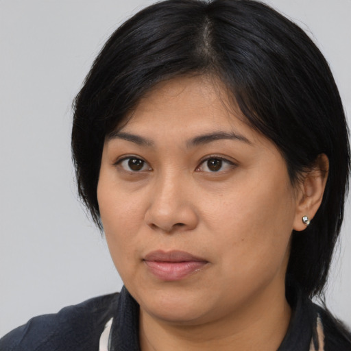 Joyful asian young-adult female with medium  black hair and brown eyes