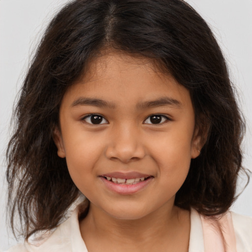 Joyful latino child female with medium  brown hair and brown eyes