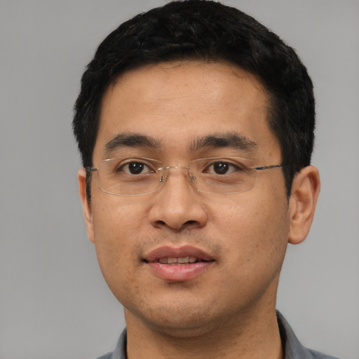 Joyful asian young-adult male with short  black hair and brown eyes