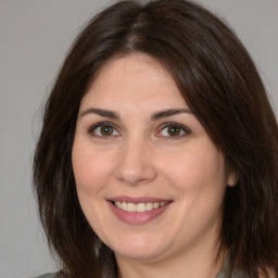 Joyful white adult female with medium  brown hair and brown eyes