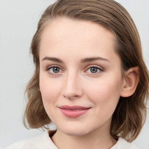 Joyful white young-adult female with medium  brown hair and blue eyes