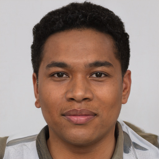 Joyful black young-adult male with short  brown hair and brown eyes