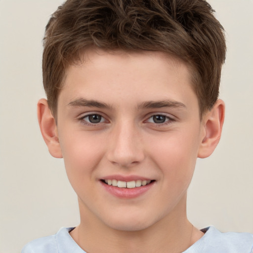 Joyful white child male with short  brown hair and brown eyes