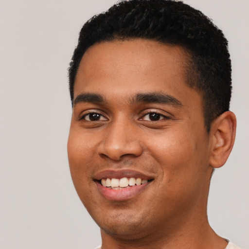 Joyful latino young-adult male with short  black hair and brown eyes